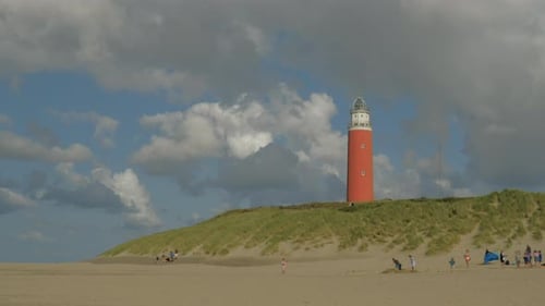 Timelapse of the Lighthouse on a Dune on Texel during summer on a half sunny day with passing clouds