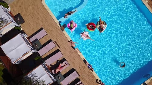 Aerial View of Adults Relaxing in Resort Pool