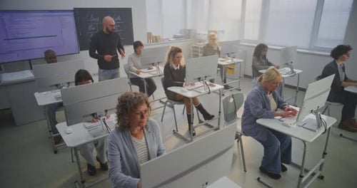 Classroom of Adults and Children Learning Computer Programming