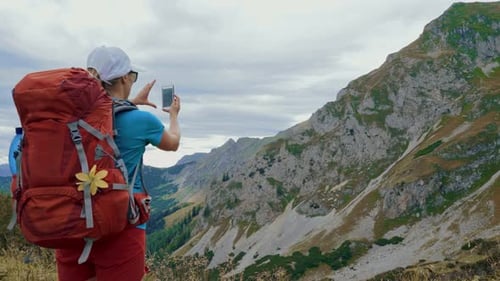 Woman Hiker Taking Pictures of Mountain Landscape