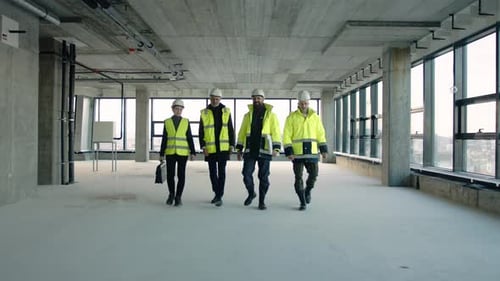 Engineers walking and talking on construction site teamwork in real estate project