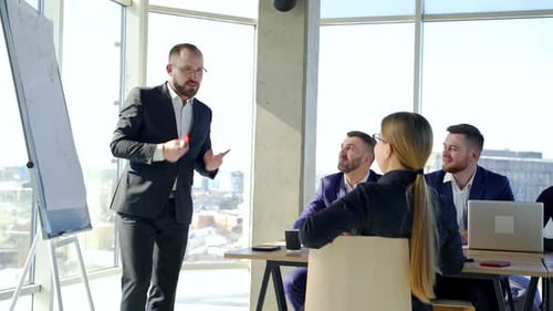 Happy business team discussing together at office meeting with laptop. Brainstorming at the office.
