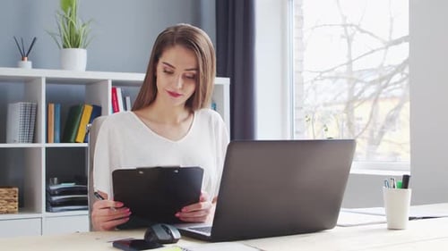 Young Woman Works at Home Office Using Computer Workplace of Female Entrepreneur Freelancer or