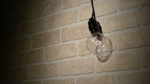 Lightbulb shatters into fragments at super slow motion recorded with phantom camera