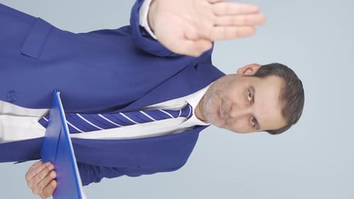 Man in Suit Holds Hand up to Stop
