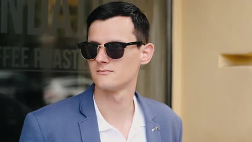 Portrait of Confident Business Man Wearing in Sunglasses and Walking at Street