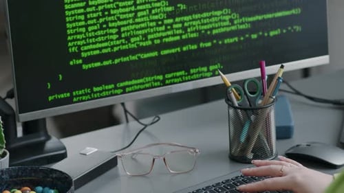Software Engineer Writing Program Code on Computer