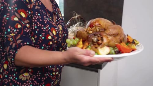 Woman Serving Roasted Turkey to Her Family at a Festive Holiday Feast