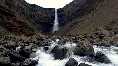 Majestic Waterfall Cascading Down Rocky Cliffs in the Heart of Icelands Stunning Landscape