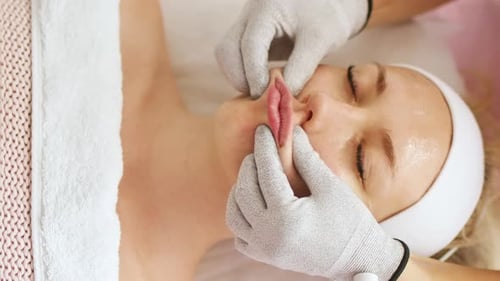 Woman Receives Lip Massage in Spa, Close Up