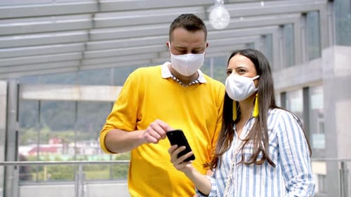 Airport holiday fun caucasian couple in face masks ready for summer vacation