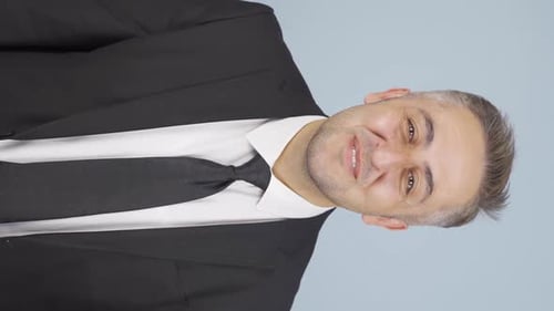 Smiling Man in Suit Waves