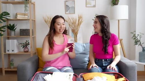 Two Friends Packing Suitcase for a Vacation