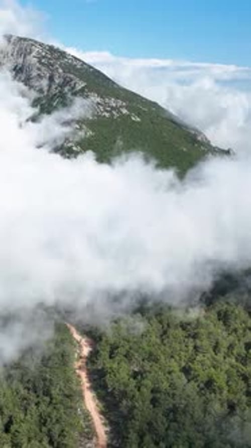 Vertical Video Enchanting Aerial View of Cloudy Mountain Landscape Nature's Serene Elegance