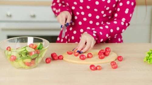 Woman Cutting Cherry Tomatoes for a Salad