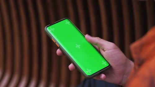 Close Up Shot of a Man Using Smartphone with Chroma Key Green Screen Outdoor Scrolling Through