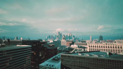 Dusk Settles on City Skyline with Construction Cranes and Plans Visible