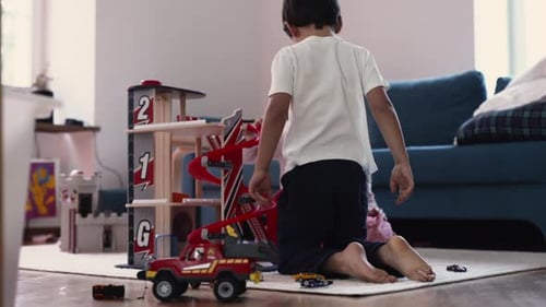 Children Playing with Car Garage Toy in Living Room