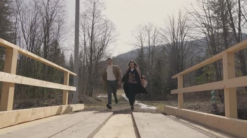 A Young Family Has Fun Running Into Nature From the City An Easy Walk in the Sun for Two Warmth and