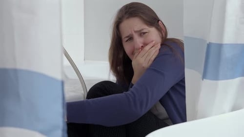Distressed Woman Crying in Bathtub