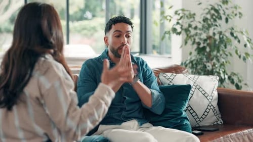 Couple, stress and fight on sofa, home and argument with affair, divorce and shout in lounge