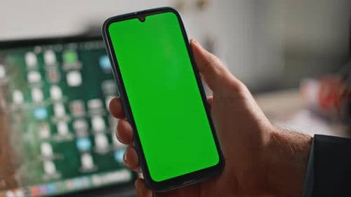 Manager Finger Scrolling Green Screen Cellphone in Modern Office Closeup
