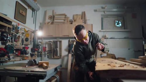 Person Working With Wood in Workshop