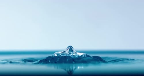 Drop close-up of water falls in a super slow motion.
