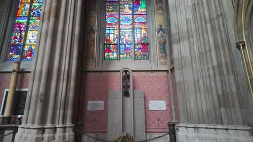 Detailed view of an altar with vibrant stained glass windows inside Votive Church, Vienna, Austria