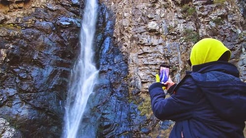 Person Take Photo Of Waterfall