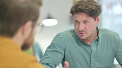 Close Up of Man Talking with Teammate in Office