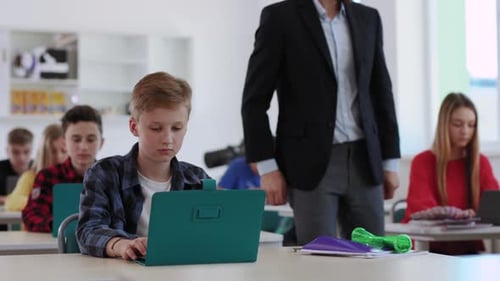 Students Actively Engage in Learning with Laptops in a Modern Classroom That Fosters Collaboration