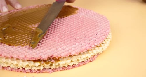 Knife Smears Peanut Butter on Waffle Cake