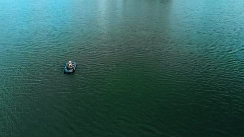 A Single Boat Peacefully Drifting on Calm Waters