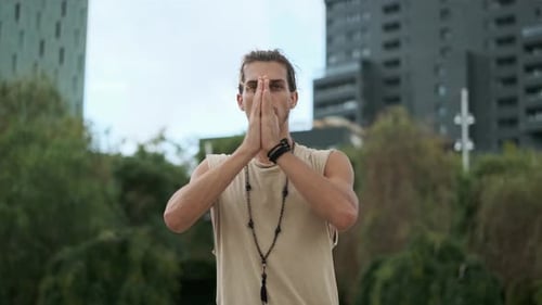 Man Doing Yoga Meditation While Standing Outdoors in a Park