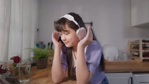 Girl Listening to Music with Headphones Indoors