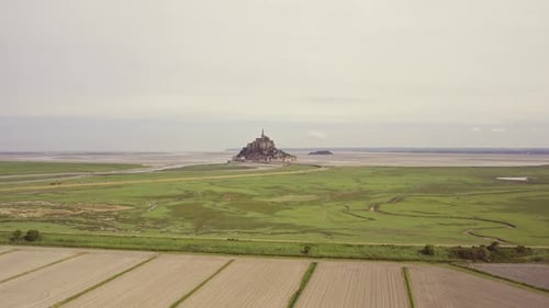 Aerial view of Mont Saint Michel abbey and fields, France.