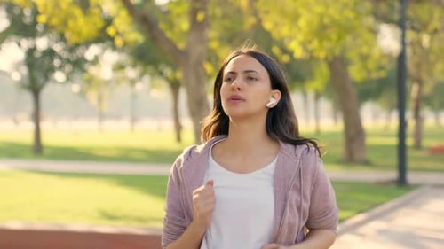 Woman Running in Park for Health and Fitness