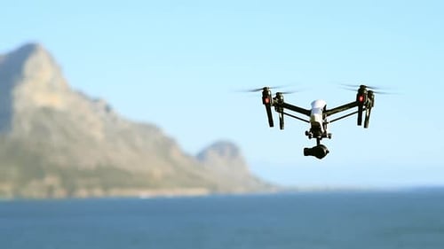 Photography, drone and flight of technology at the beach filming sea landscape with water