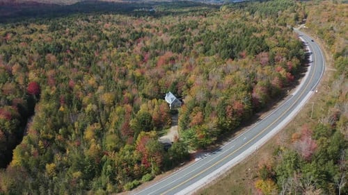 Aerial View of Freeway and Isolated House in Colorful Forest on Sunny Autumn Day in Countryside of N