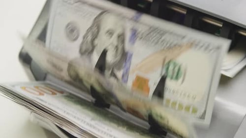 CloseUp of Money Counting Machine with Hundred Dollar Bills