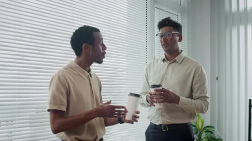 Male Managers Communicating during Coffee Break at Office