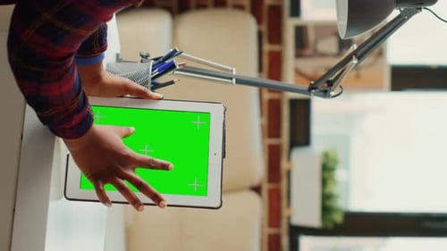 Vertical Video Female Worker Vertically Holding Modern Gadget with Green Screen Template