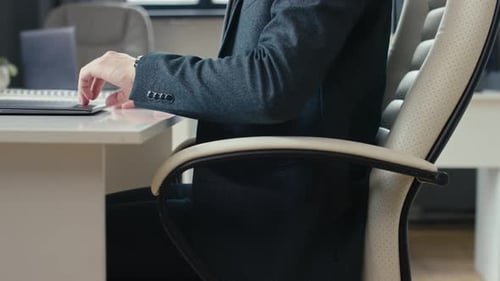 Man Typing on Laptop at Office Desk