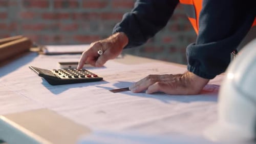Ruler, hands and calculator at blueprint for planning, calculating measurements and review