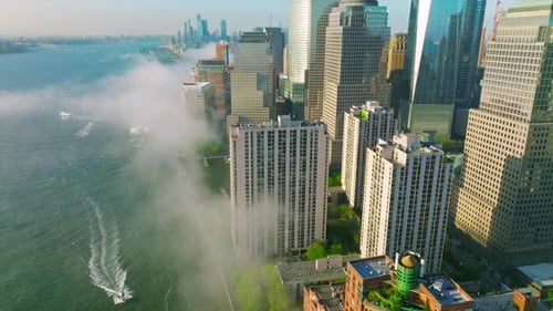 Manhattan Island skyscrapers reflecting morning sun.
