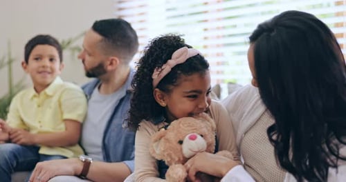 Family Sitting Together on the Couch Indoors
