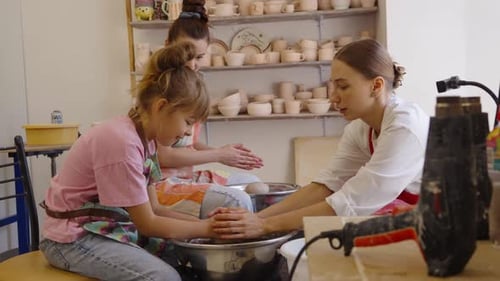 Kids Learn Pottery Techniques in a Fun Art Class in a Bright Studio