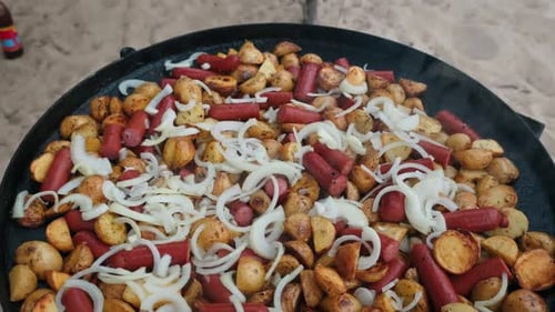 Fried Potatoes and Sausage being Cooked at the Beach