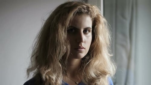 Young Woman with Blonde Hair Looking Thoughtful Indoors